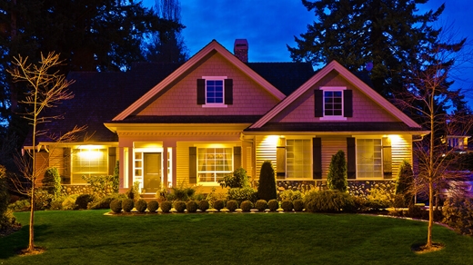 beautiful home at dusk with lights on